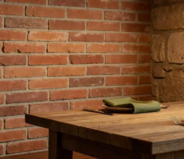 Dining room details at Fold & Feast with oak tables, terracotta tones, and rustic stone elements